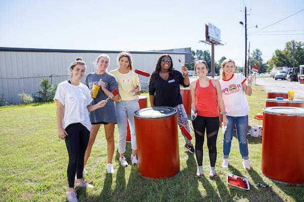 Honors students participate in a service project to paint a local business.